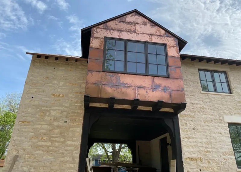 Copper metal panel facade on a stone building for Skylight Installation in Steilacoom